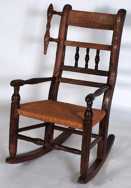 Appraisal: NINETEENTH CENTURY CHILD'S OAK AND RUSH SEATED WINGED ROCKING CHAIR