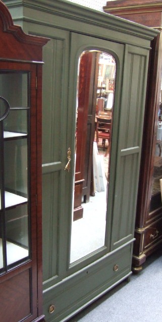 Appraisal: A green painted late th century wardrobe the bevelled mirror