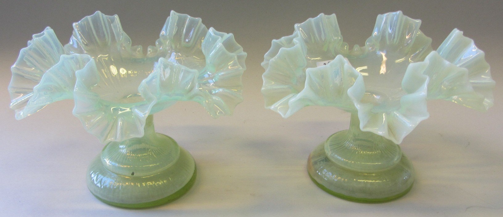 Appraisal: A pair of th century vaseline glass posy vases with