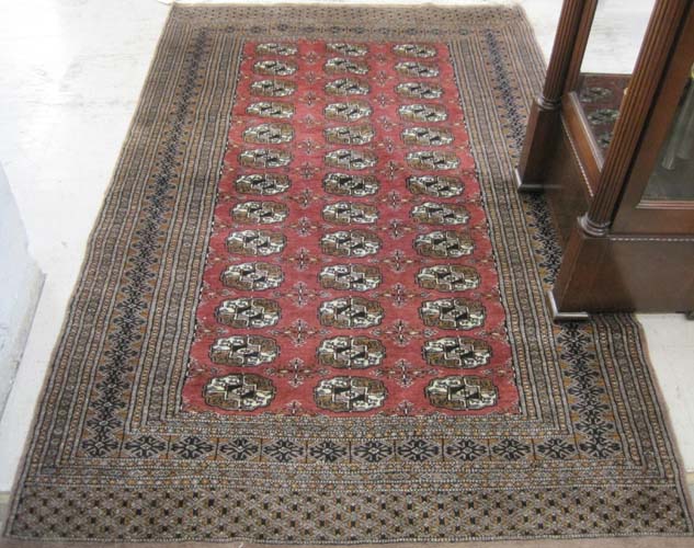 Appraisal: HAND KNOTTED ORIENTAL AREA RUG Pakistani Bokhara repeating columns of