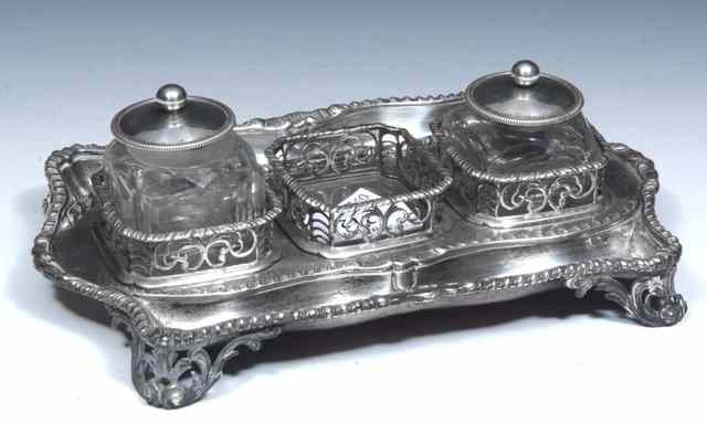 Appraisal: A GEORGIAN SILVER THREE DIVISIONAL INKSTAND with pierced decoration scrolled