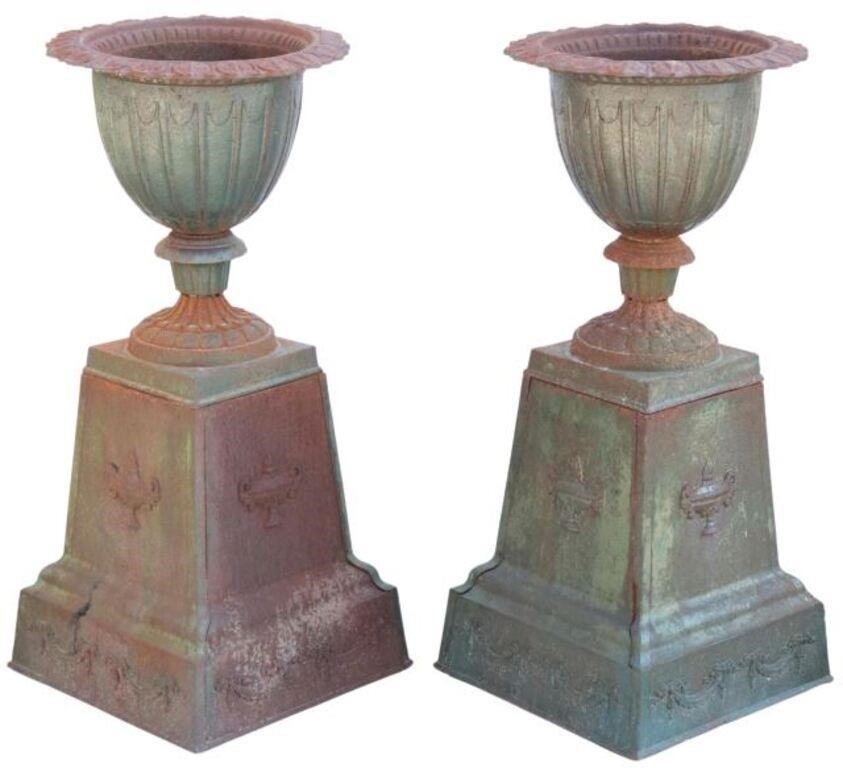 Appraisal: pair Cast iron garden urn planters on plinths having foliate