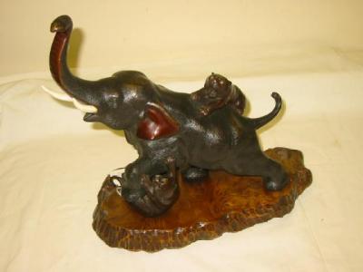 Appraisal: A JAPANESE BRONZE GROUP modelled as an elephant fighting two