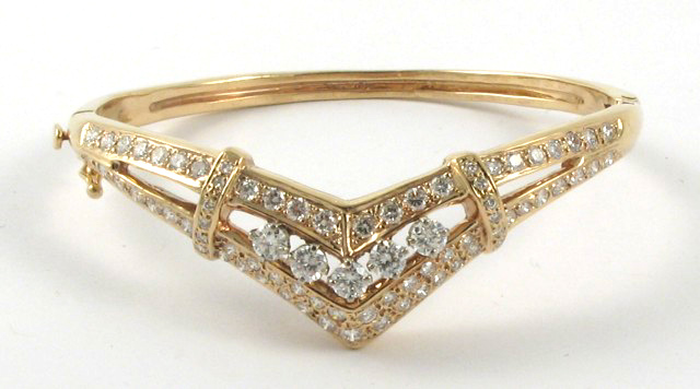 Appraisal: DIAMOND AND FOURTEEN KARAT GOLD BANGLE The yellow gold chevron