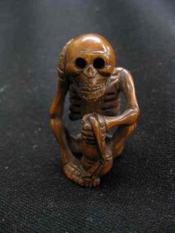 Appraisal: Carved Wooden Netsuke of a Skeleton seated ''thinking'' '' excellent