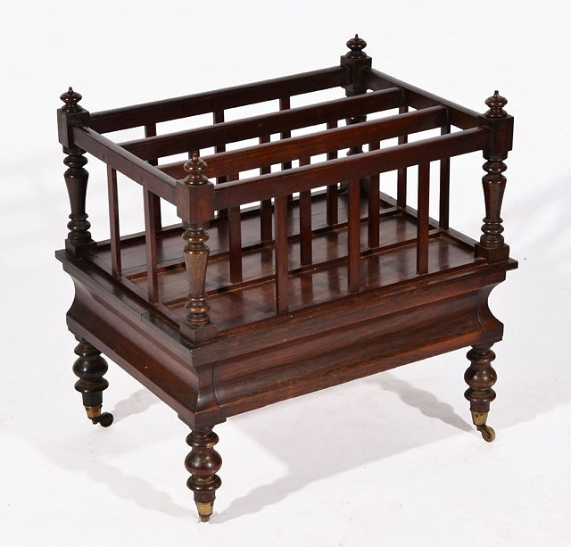 Appraisal: A VICTORIAN ROSEWOOD MUSIC CANTERBURY with turned supports legs and