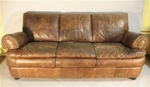 Appraisal: MODERN LEATHER SOFA th century the tight back and cushions