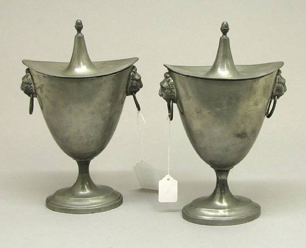 Appraisal: A pair of Continental pewter covered chestnut urns th century