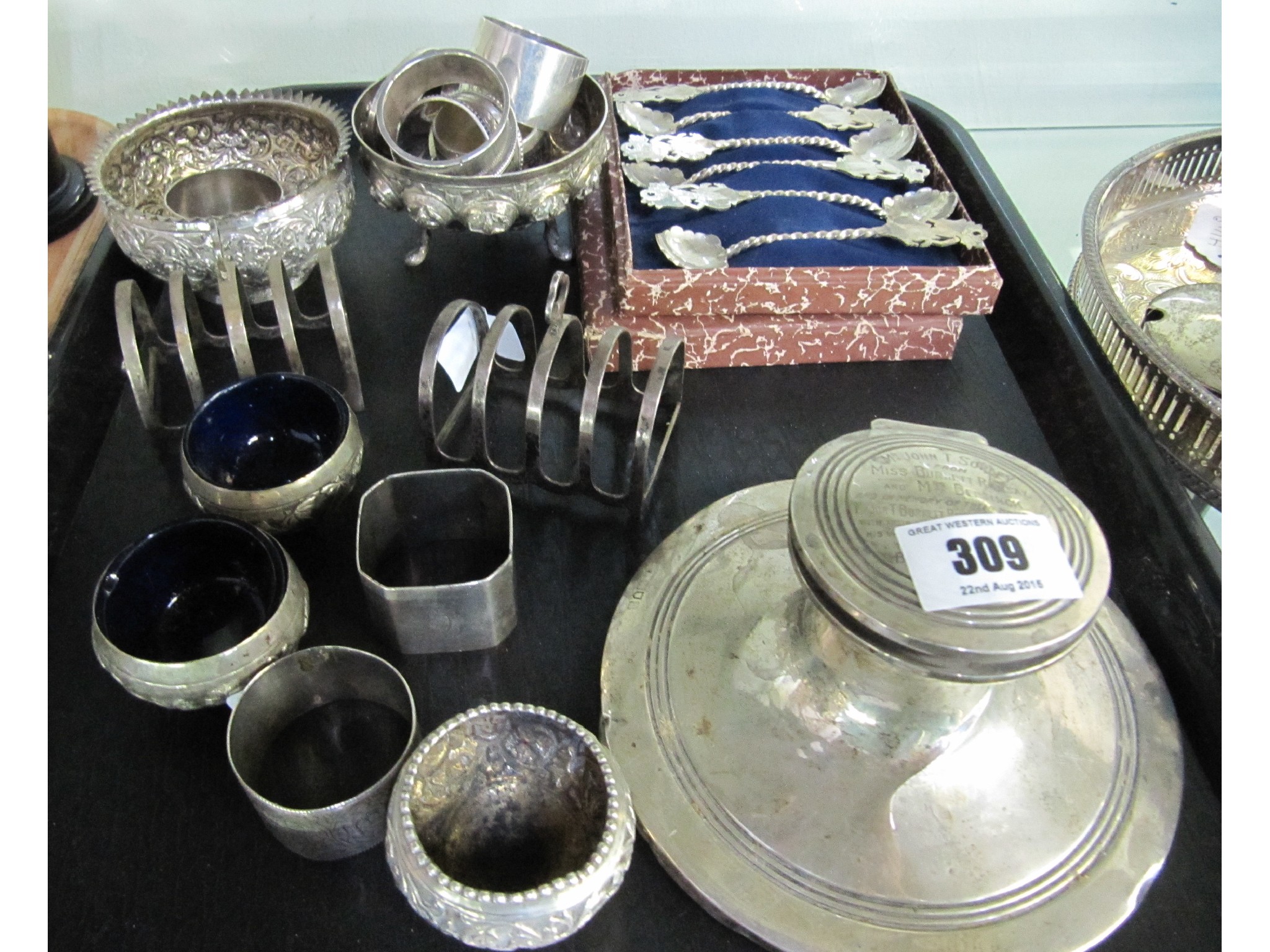 Appraisal: A tray lot of silver napkin rings toastrack inkwell spoons