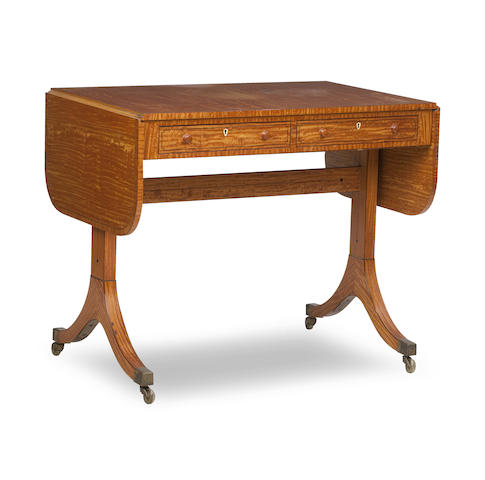 Appraisal: An Edwardian Regency-style satinwood sofa table The rectangular top with