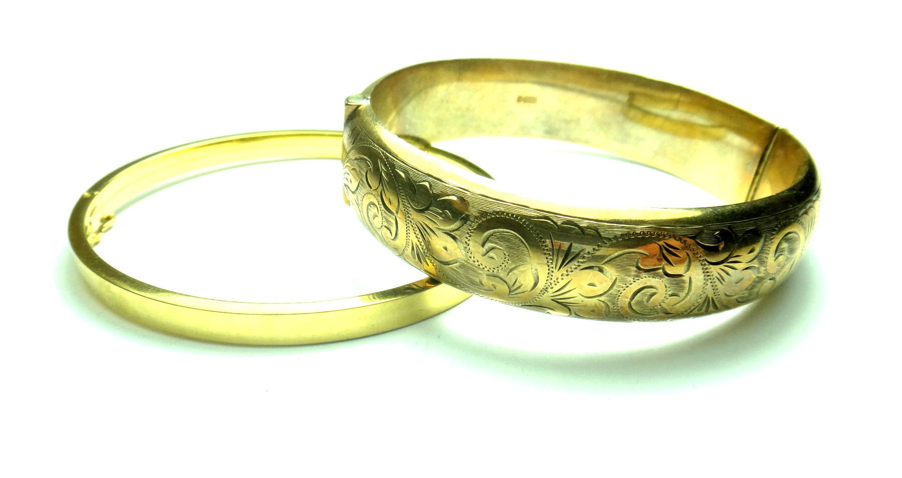 Appraisal: A ct gold oval hinged bangle the front with scroll