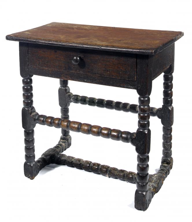 Appraisal: A CHARLES II JOINED OAK TABLE with boarded top and