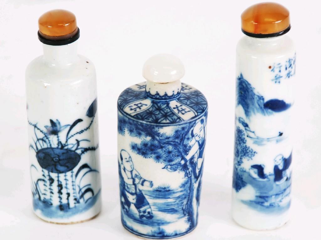 Appraisal: THREE CHINESE PORCELAIN SNUFF BOTTLES with associated stoppers each painted