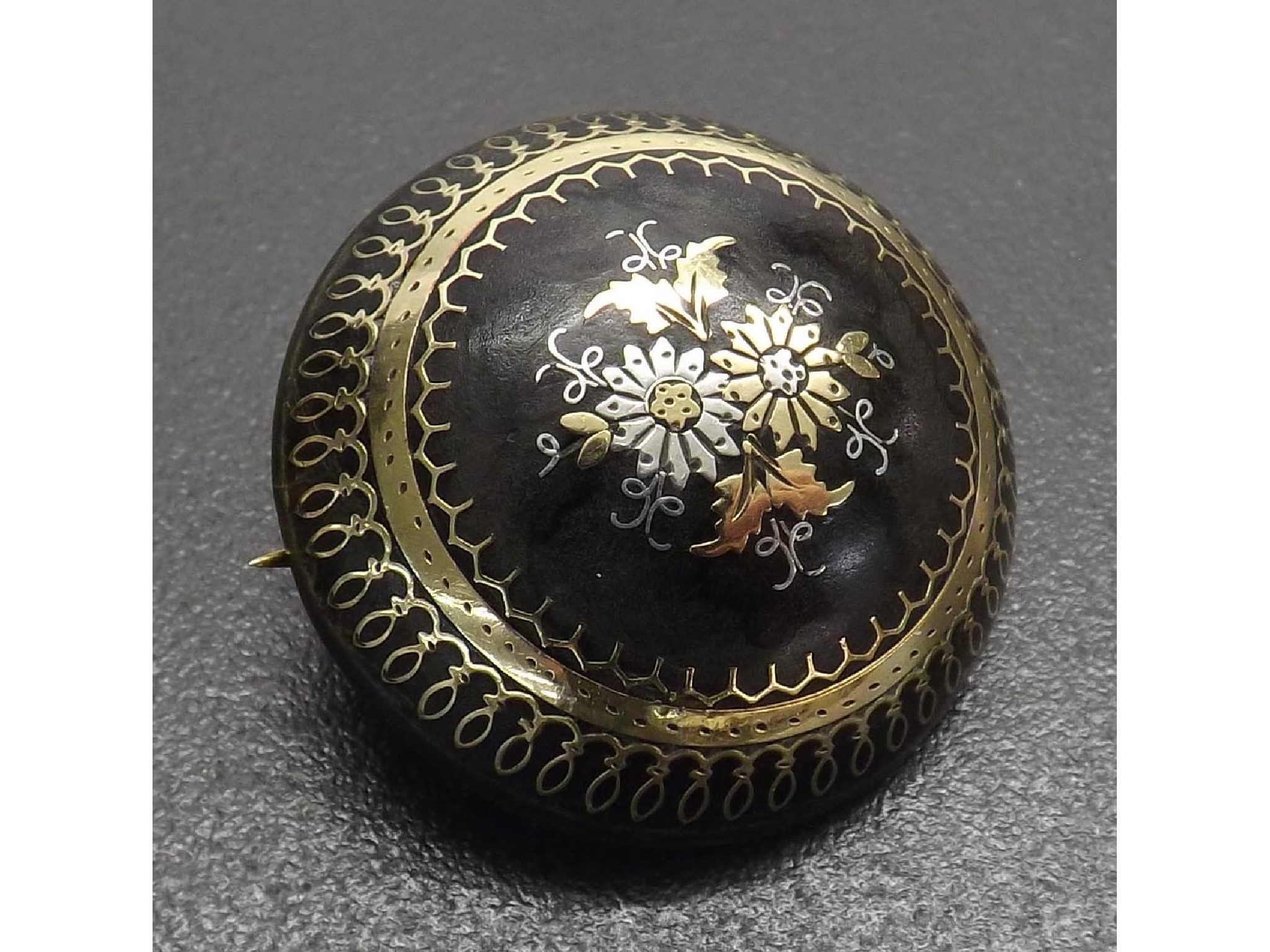 Appraisal: th century pique tortoiseshell circular brooch with foliate designs mm