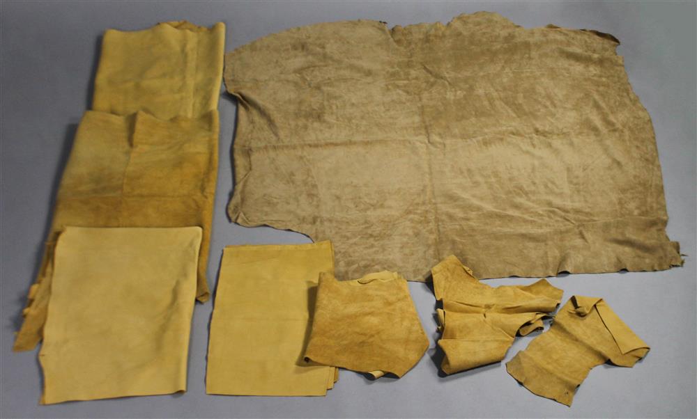 Appraisal: THREE LARGE LEATHER HIDES A LARGE SUEDED HIDE AND TWO