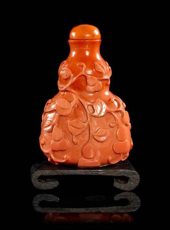 Appraisal: A Coral Colored Glass Double Gourd Snuff Bottle having relief