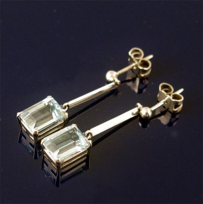 Appraisal: A pair of aquamarine earrings the step cut stones suspended