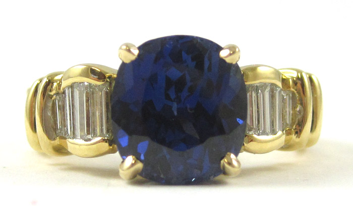 Appraisal: DIAMOND AND SYNTHETIC SAPPHIRE RING k yellow gold with baguette