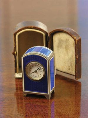 Appraisal: A French silver coloured metal and guilloche enamel miniature clock