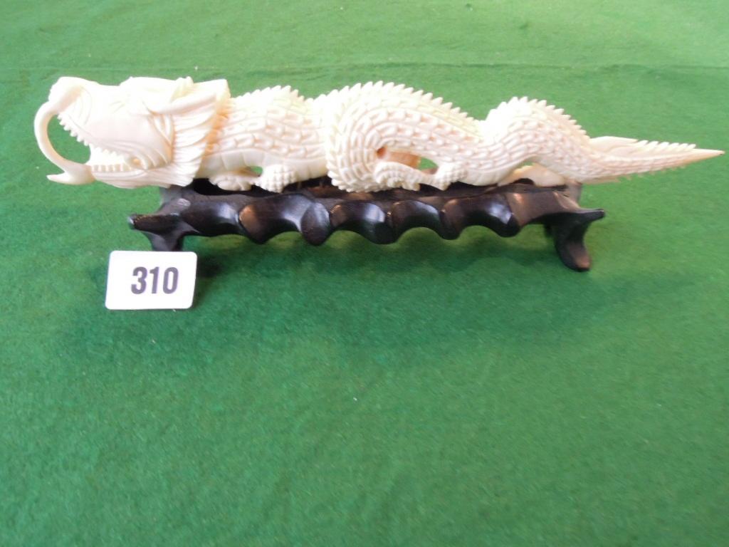 Appraisal: A carved Chinese ivory ceremonial dragon on hardwood base