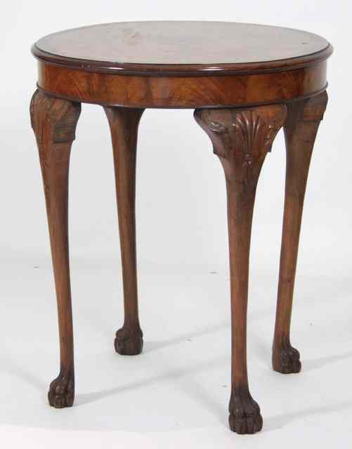 Appraisal: A circular walnut table on cabriole legs with paw feet