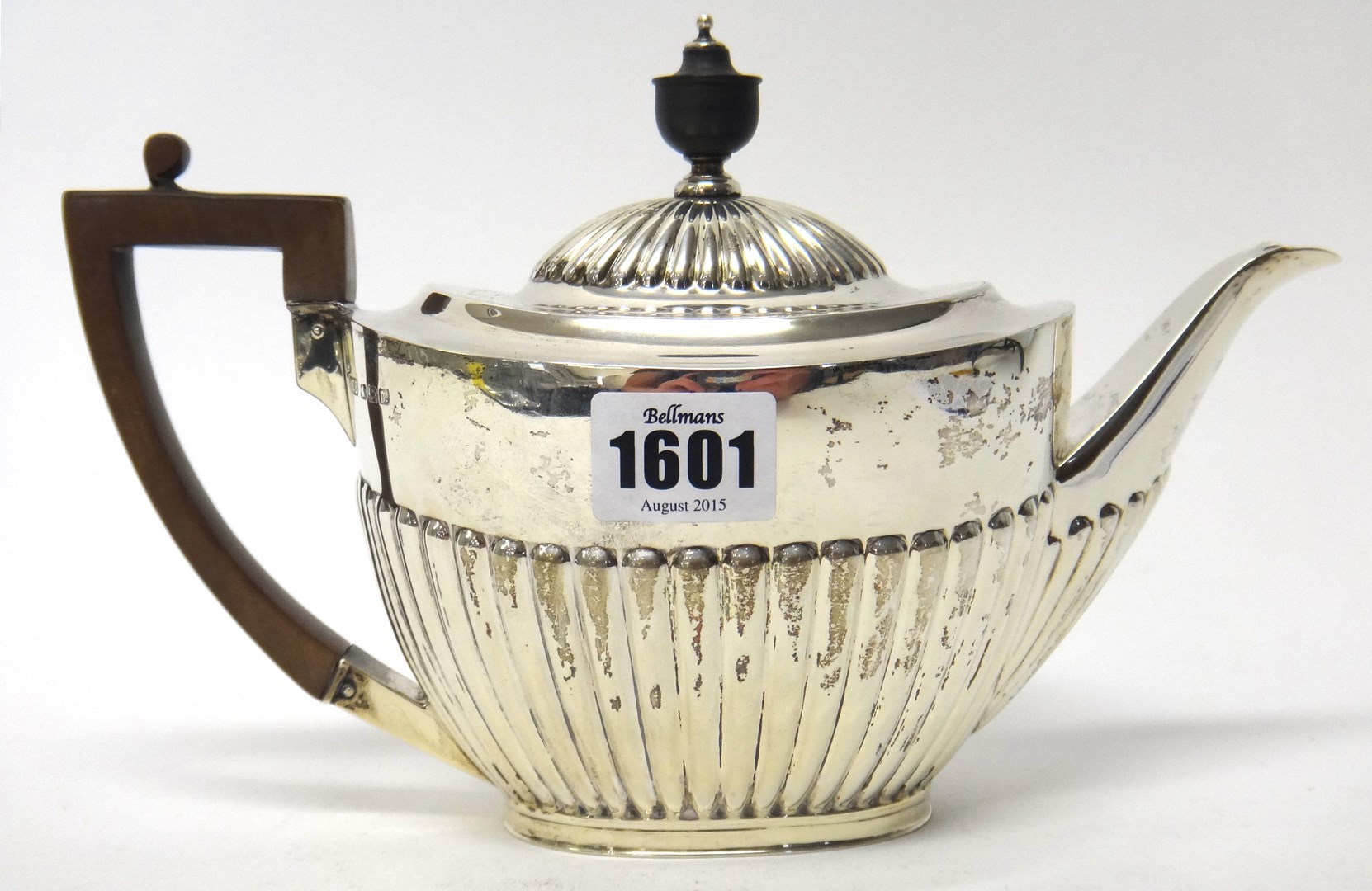 Appraisal: A silver teapot of oval form with partly fluted decoration