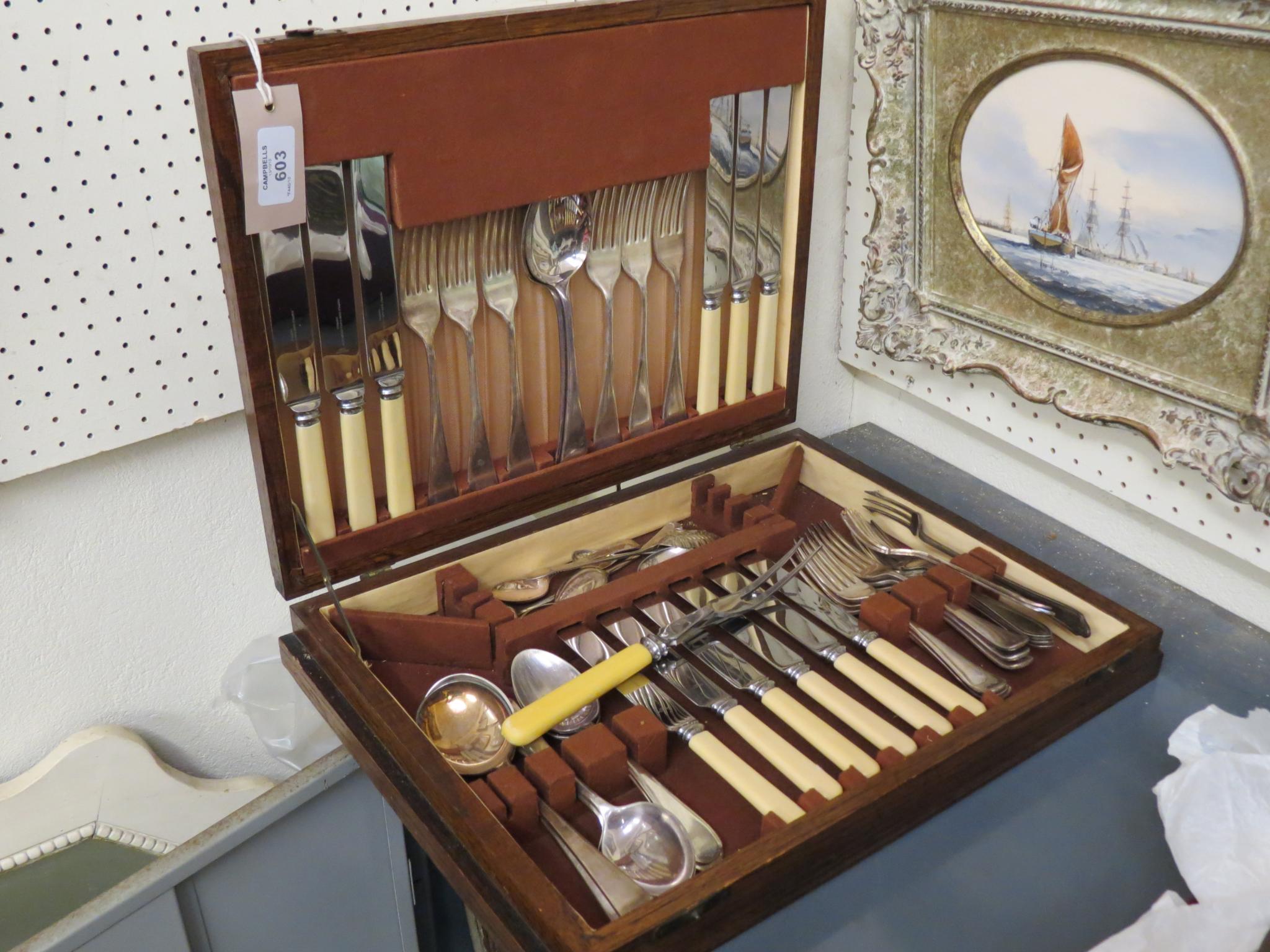 Appraisal: An oak canteen containing a suite of silver plated cutlery