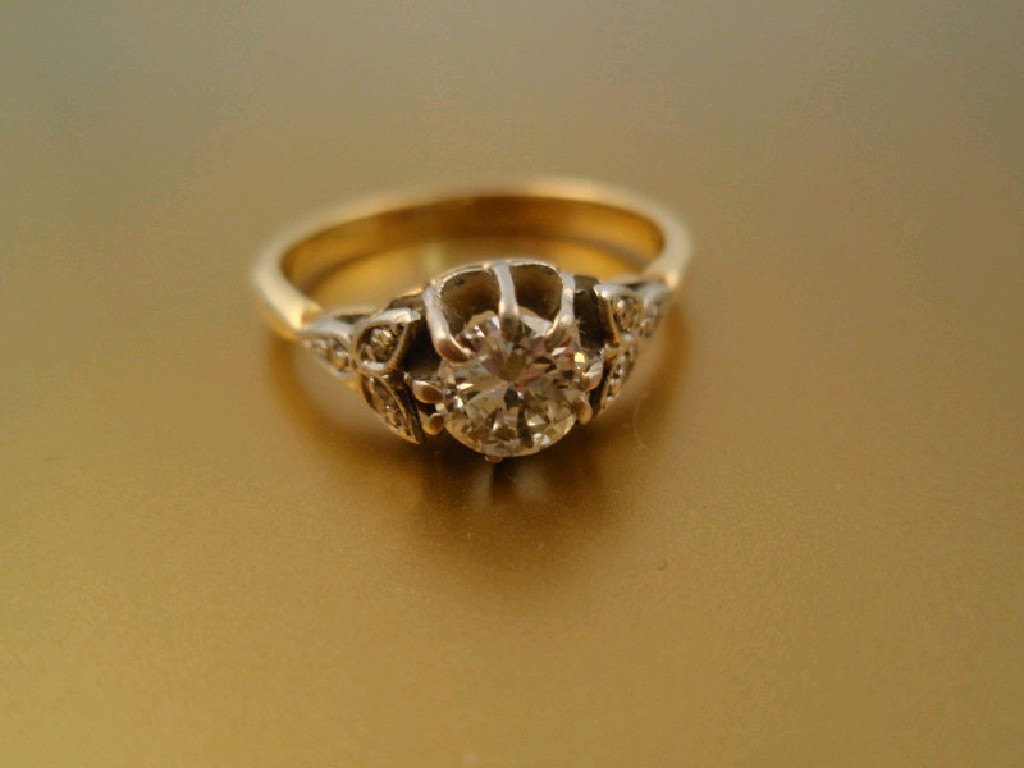 Appraisal: A solitaire diamond ring of ct approx with three tiny