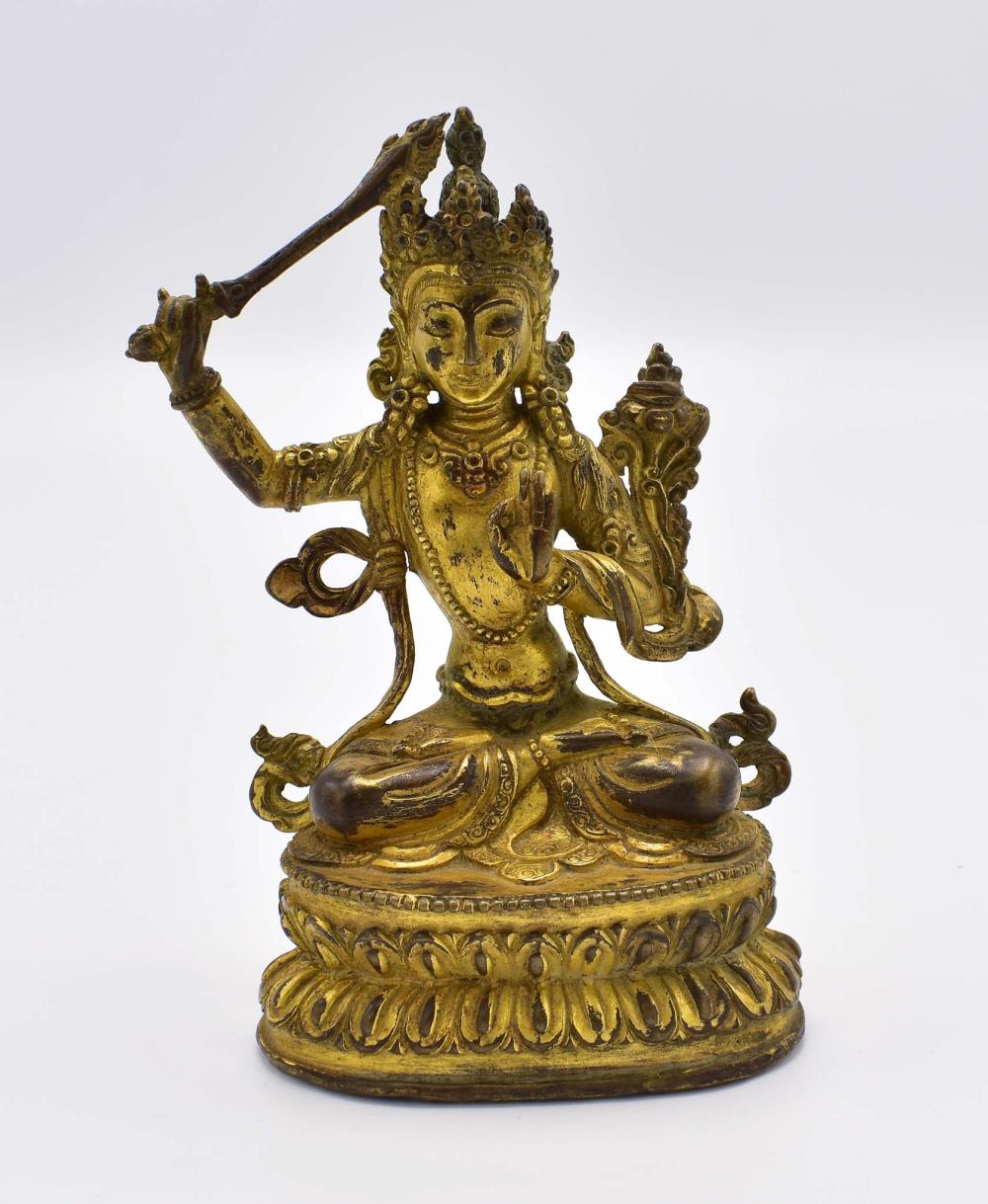 Appraisal: SINO-TIBETAN GILT BRONZE SEATED DEITYElaborately dressed the headdress supporting a