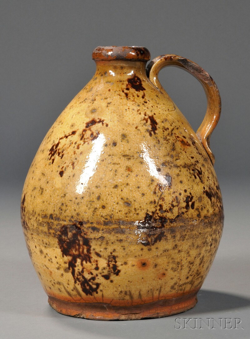 Appraisal: Manganese Splotch-decorated Yellow-glazed Redware Jug America early th century ovoid