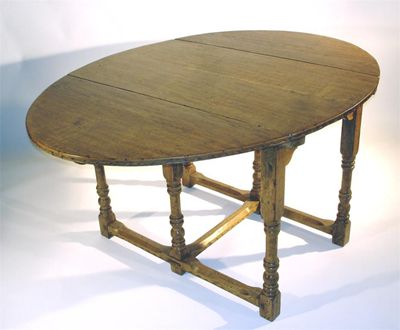 Appraisal: An Arts and Crafts oak drop leaf table the design