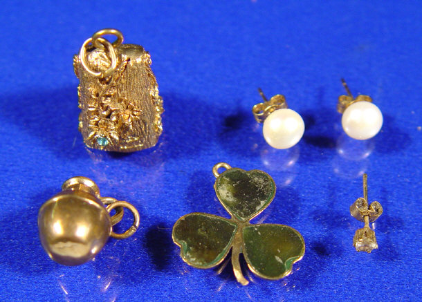 Appraisal: Gold charms and a pair of pearl earrings