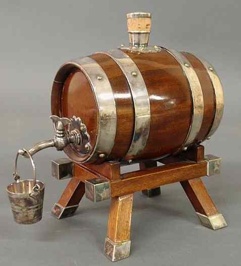 Appraisal: Mahogany and silver banded whiskey barrel form bar dispenser with