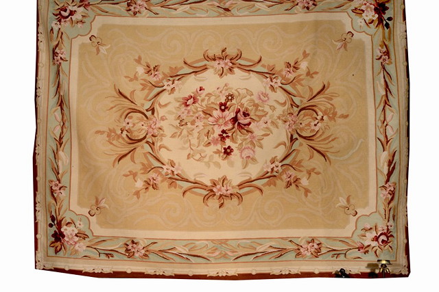 Appraisal: AN AUBUSSON STYLE WOOL CARPET with running borders and floral