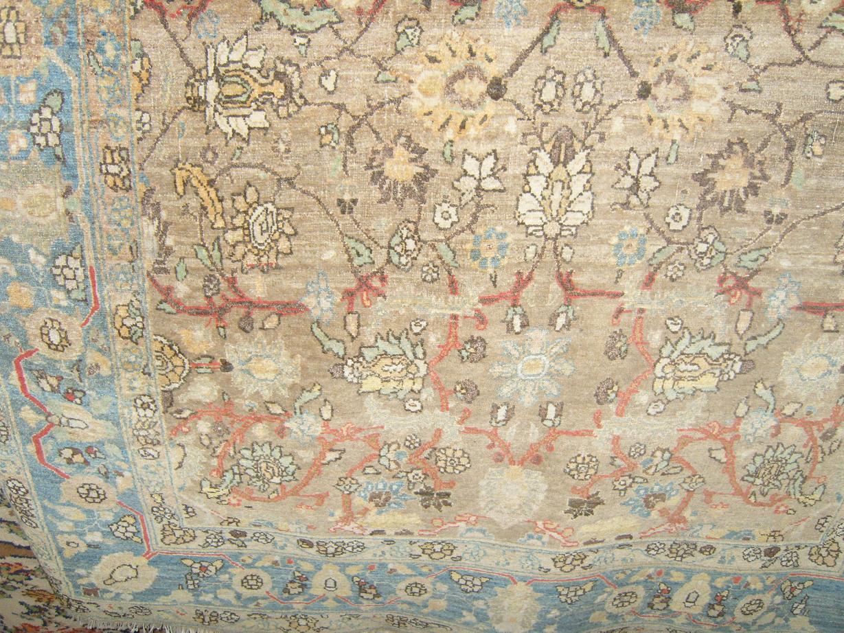 Appraisal: A beige ground eastern wool carpet with trailing flower and