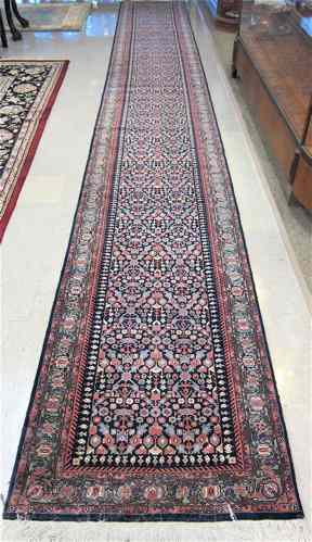 Appraisal: HAND KNOTTED ORIENTAL LONG RUG Indo-Persian overall floral design in