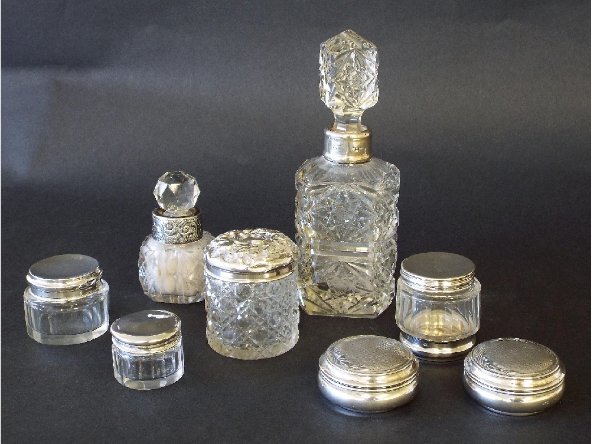 Appraisal: Collection of various silver topped glass bottles to include a