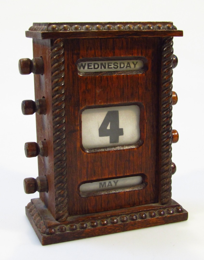 Appraisal: A s oak cased desk calendar of rectangular part beaded