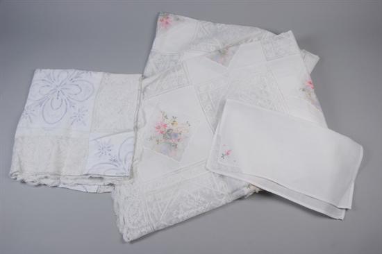 Appraisal: THREE WHITE LINEN CUT-WORK AND EMBROIDERED TABLECLOTHS One with multi-colored