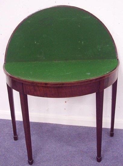 Appraisal: A George III mahogany half round card table the folding