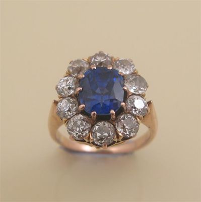 Appraisal: A sapphire and diamond cluster ring The oval shaped sapphire