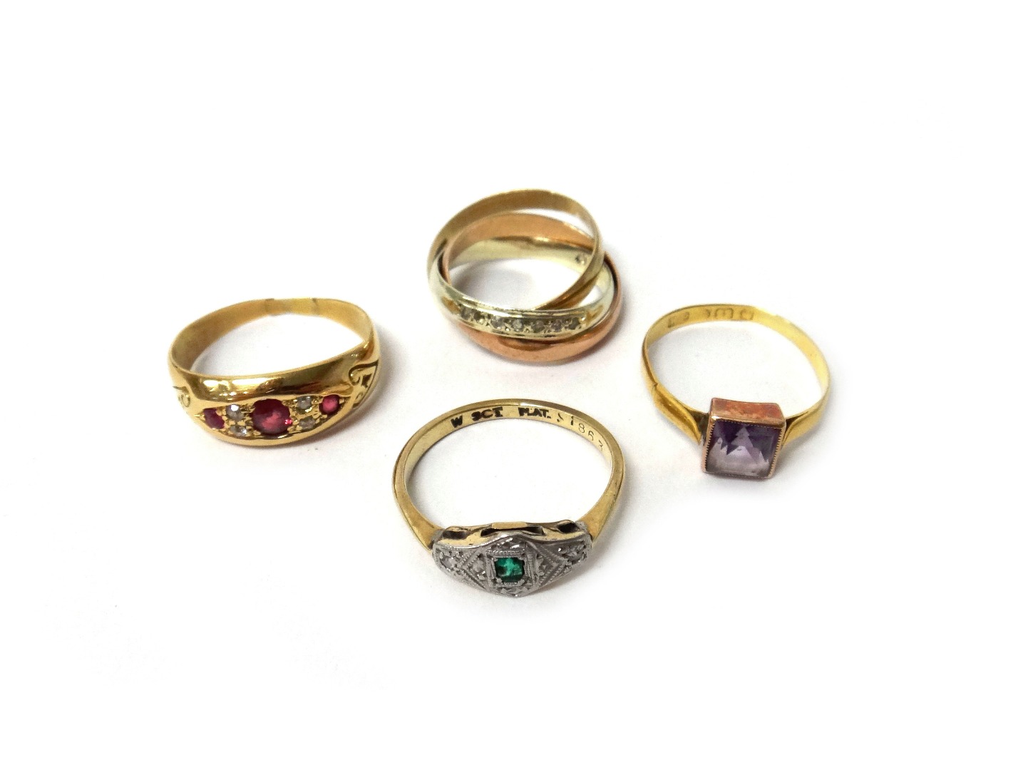 Appraisal: A gold ring mounted with three cushion shaped rubies and