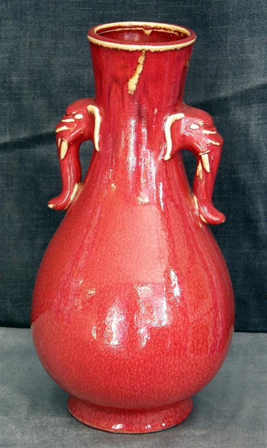 Appraisal: Twentieth century Red glazed vase with elephants head handles h