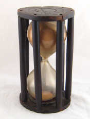 Appraisal: A th c hourglass in six column wooden cage ht