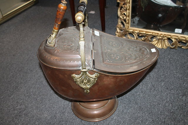 Appraisal: A VICTORIAN HELMET SHAPED COPPER COAL SCUTTLE with turned wood