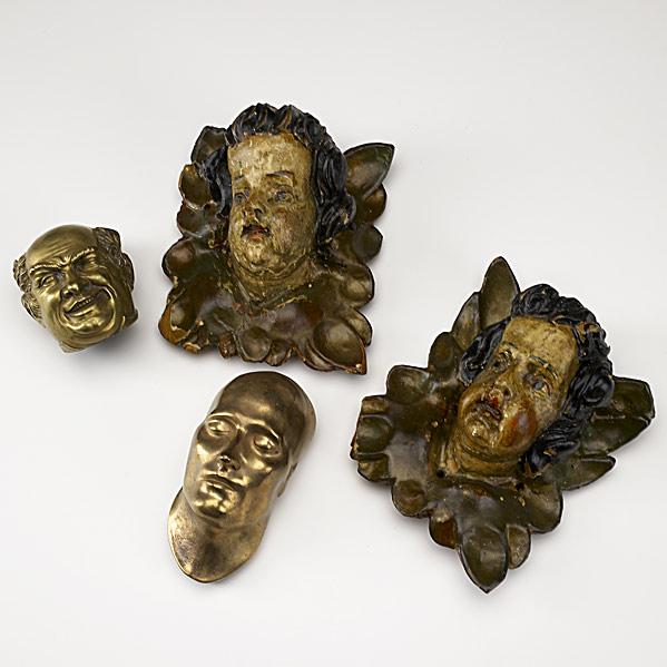 Appraisal: DECORATIVE ACCENTSPair of polychrome wood carvings of heads together with