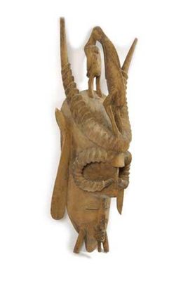 Appraisal: A Senufo mask with a human face having bared teeth