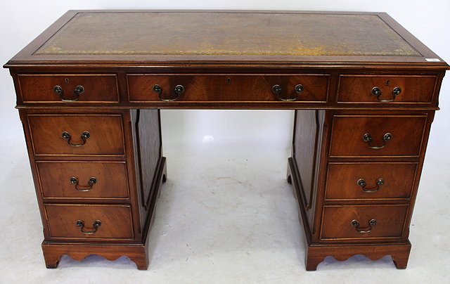 Appraisal: A MAHOGANY PEDESTAL DESK with brown leather inset top standing