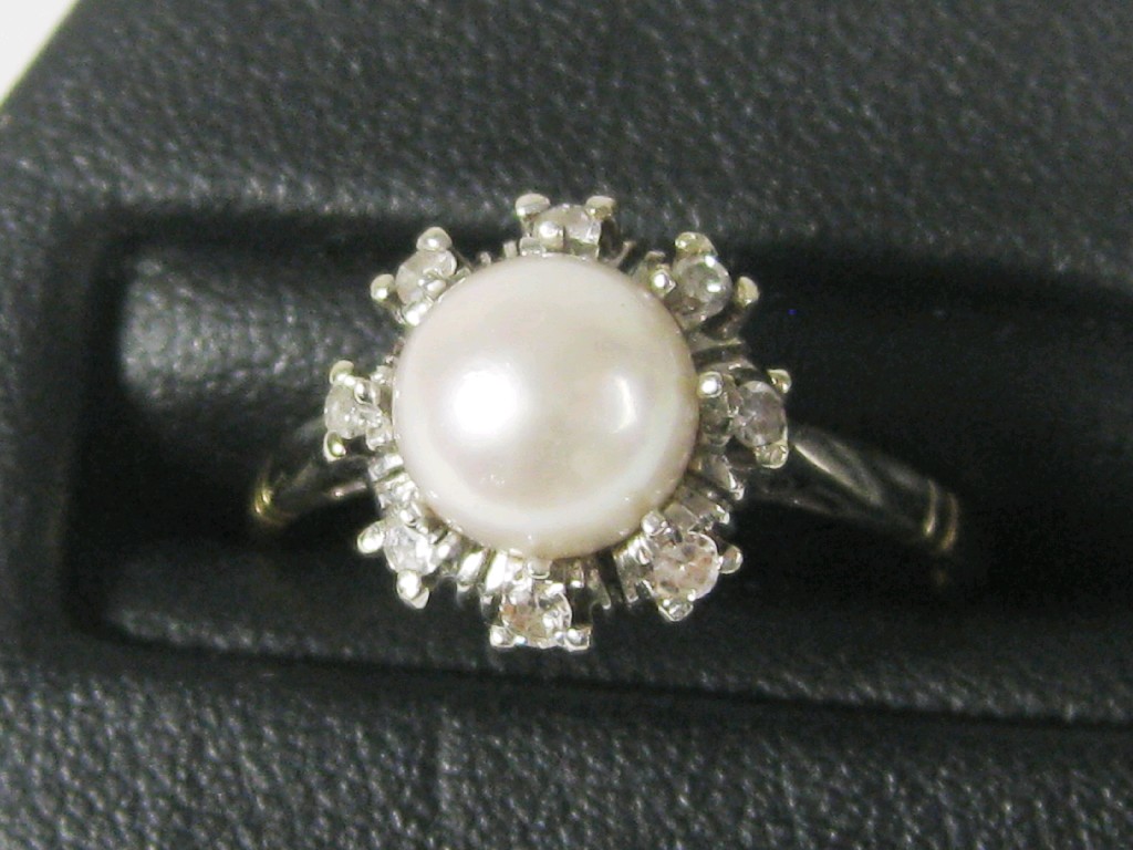 Appraisal: A Pearl and Diamond Cluster Ring the central cultured pearl