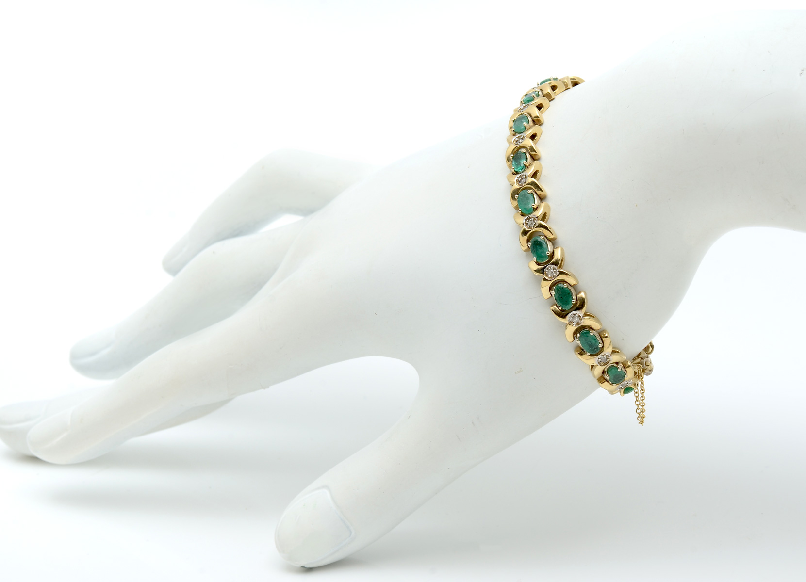 Appraisal: K EMERALD DIAMOND BRACELET K yellow gold bracelet contains oval